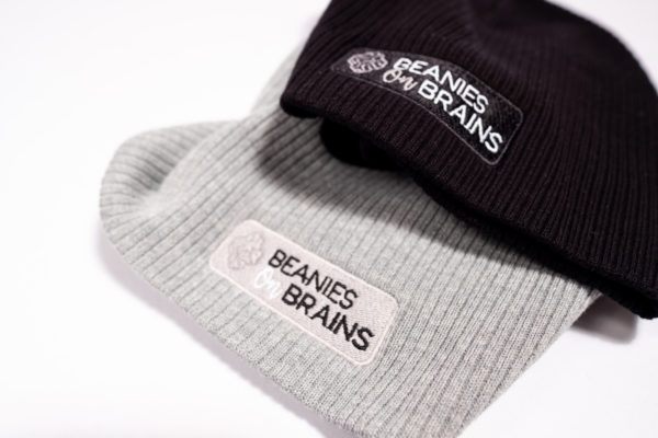 Gray and black beanies with Beanie On Brains logo